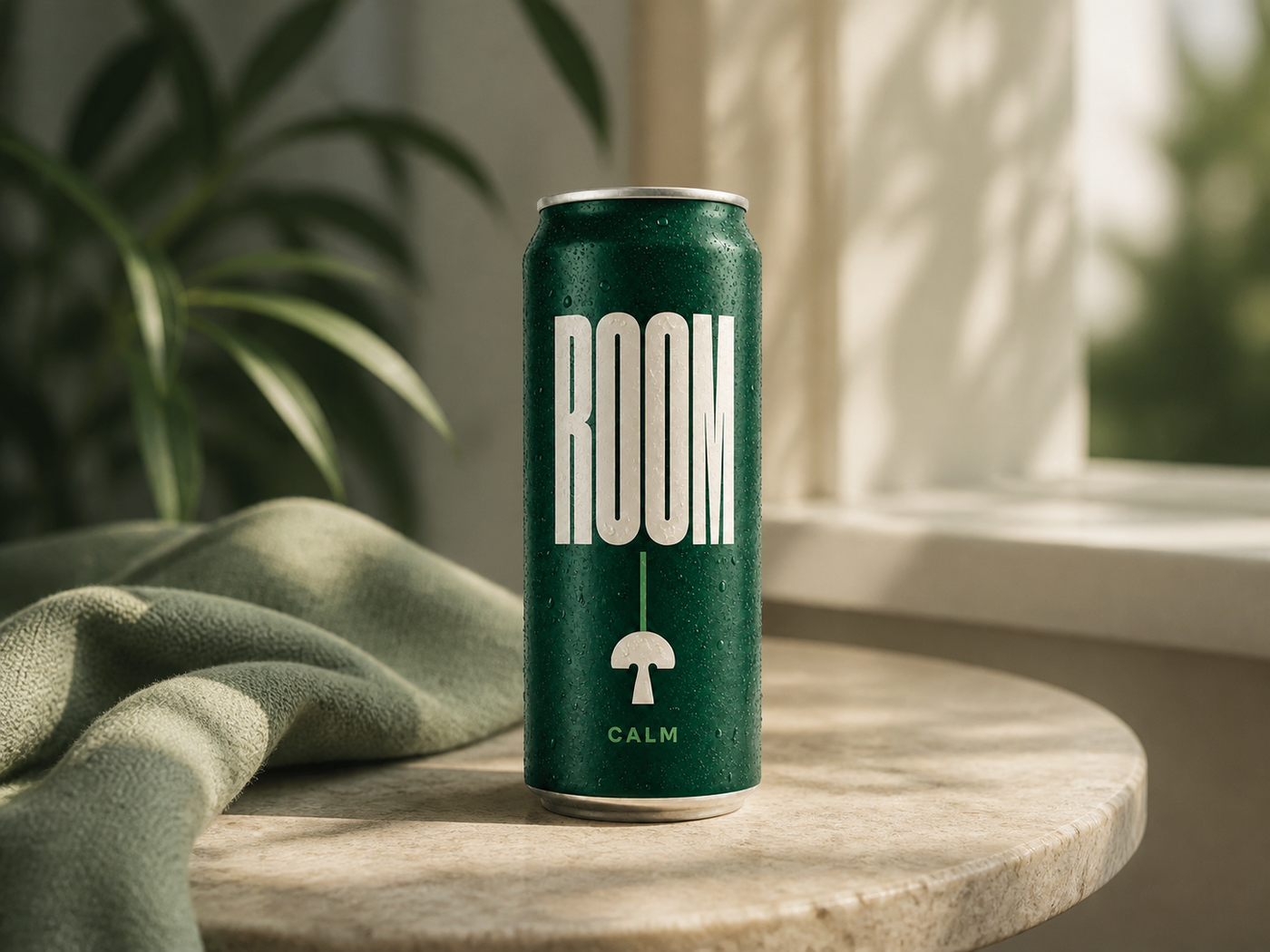 ROOM Calm can on a sunlit table beside a soft green throw